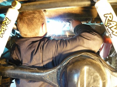 Welding a bracket under the body to fix the new handbrake assembly to