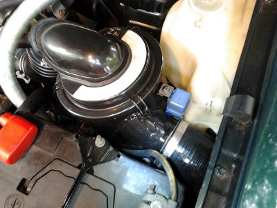 Silicone hose clamped to inlet is a massive 3 or 4&quot; 90 degree unit. Goes in to guard and turns toward mirror. The idea is that a snorkel can later be fitted, run inside guard to just before the door, rather than running whole pipe externally.