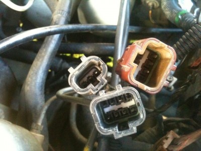 The large grey plug has the green/white wire and green/brown wire which loop via the reverse switch