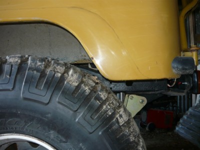 the axle hanging as far forward as the shackle will allow...